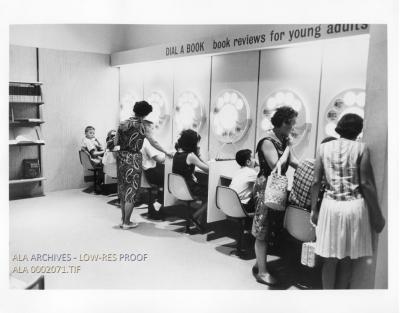 A group of children and adults at an exhibit.